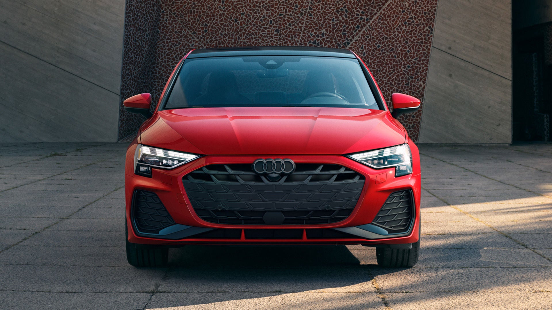 Front profile view of an Audi A3 parked.